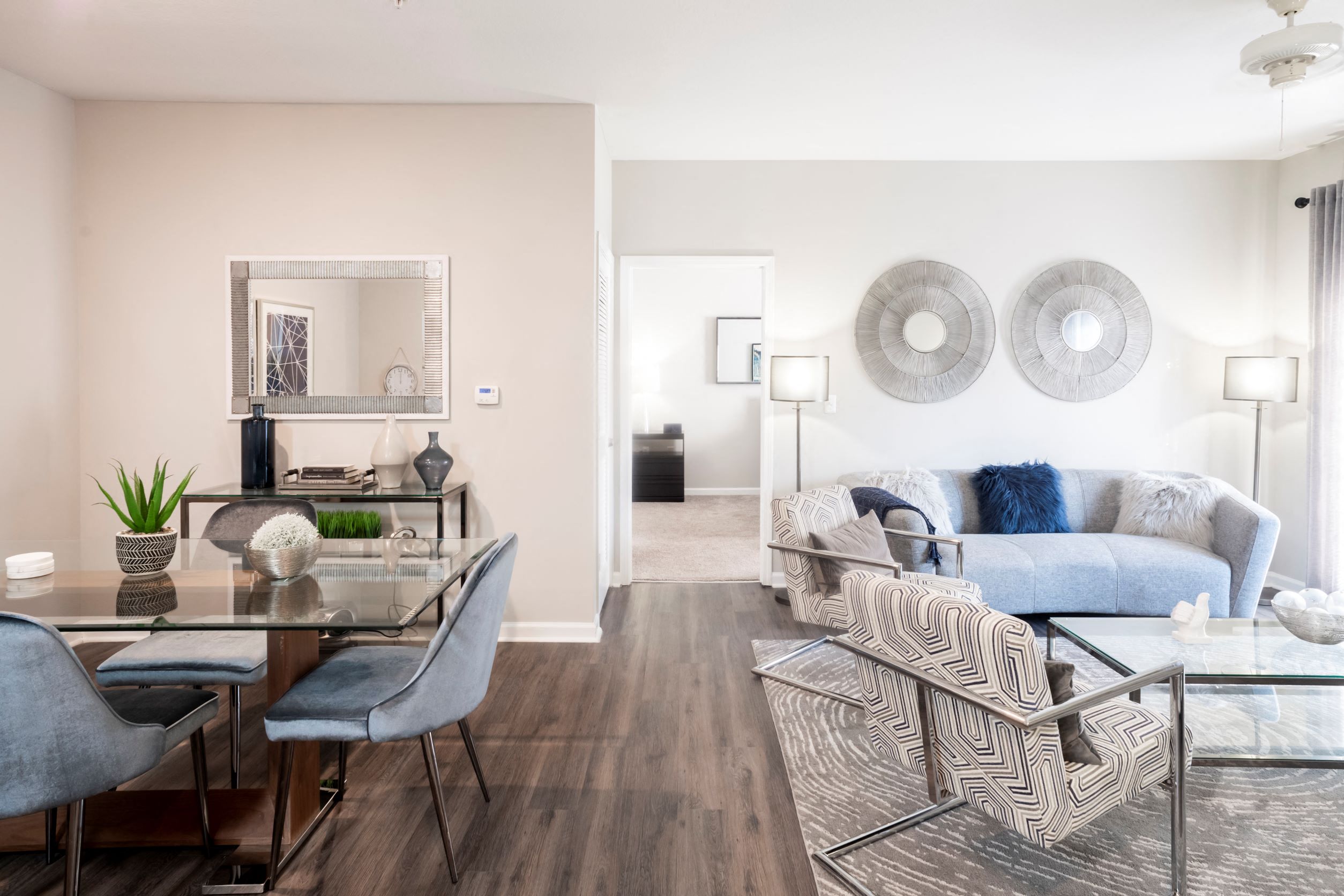 a living room with a couch and a glass table